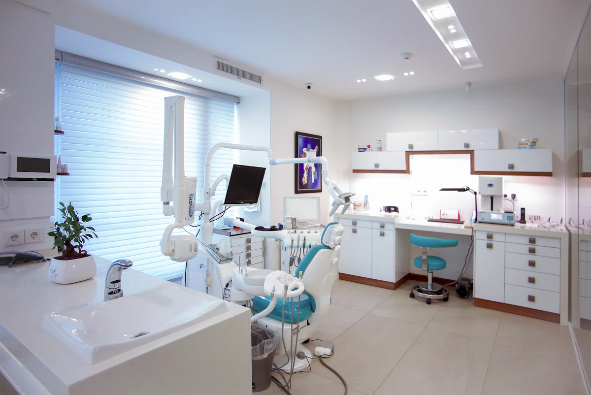 A spotless treatment room with a modern dental chair and large window