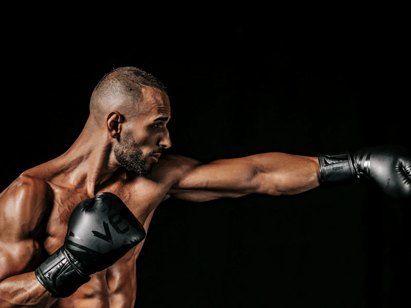 Boxer throwing a straight punch against a black background