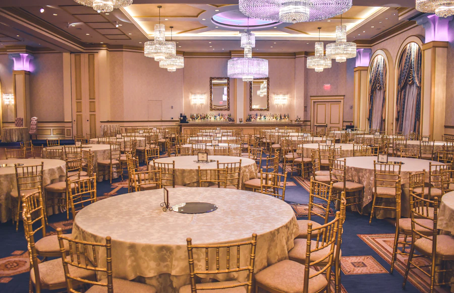 Grand ballroom set with round tables and chandeliers