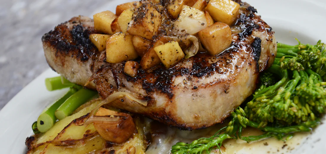 Grilled chop with roasted potatoes and charred broccolini